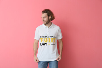 Handsome young man in stylish polo shirt on pink background. International T-shirt Day
