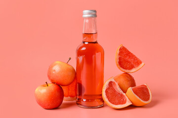 Bottle of tasty soda and fruits on color background