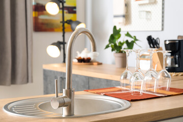 Wooden counter with silver sink in kitchen