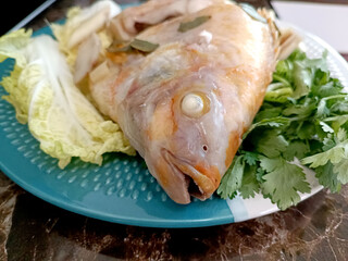 Steamed Fish with Chili Lime Sauce,thai Traditional Thai food. : thai style steamed fish on table close up 