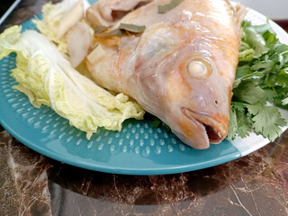 Steamed Fish with Chili Lime Sauce,thai Traditional Thai food. : thai style steamed fish on table close up 