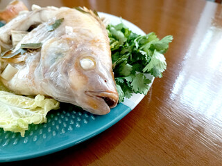 Steamed Fish with Chili Lime Sauce,thai Traditional Thai food. : thai style steamed fish on table close up 