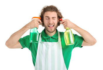 Funny worker of cleaning service with bottles of detergent on white background