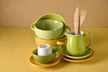 Fototapeta na wymiar Set of stylish dinnerware on yellow background
