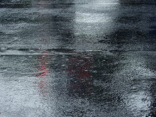raindrops falling on wet asphalt road with reflection - 500355902