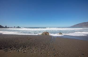 Gravel strewn on beach at the Original Ragged Point at Big Sur on the Central Coast of California United States