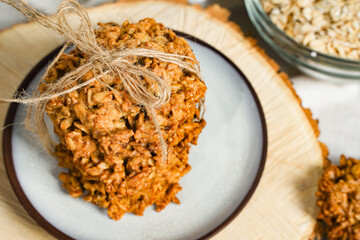 The oatmeal cookies, healthy breakfast cereal oat crackers and oat flakes. Crispy anzac biscuit cookie on rustic table