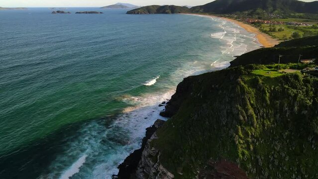 Ocean waves rolling into beautiful natural coastline, Geriba beach, Buzios, Brazil