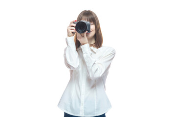 Portrait of a young woman in a white shirt taking pictures with a camera. The concept of a successful photographer, wedding photographer, photo for documents. Isolated on white background.