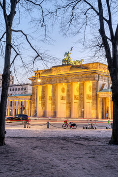 The Brandenburg Gate in Berlin early in the morning seen through some trees