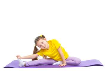 Little cute girl is practicing stretching on a gymnastic mat. Isolated on white background.