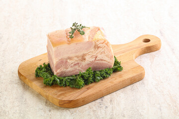 Cut of pork bacon over board