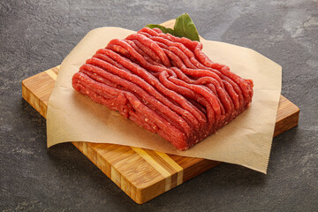 Raw beef minced meat over board