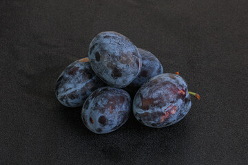 Ripe plum heap over background