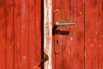 Door handle on old painted wooden door