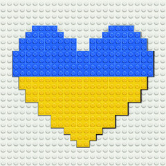 Vector illustration of yellow blue plastic bricks in heart shape on white baseplate. National Ukrainian flag.