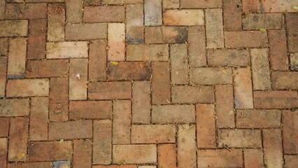 red brick for pavement, a small rectangular block typically made of fired or sun-dried clay, used in building.