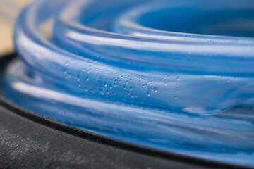 Condensed water droplets in a clear blue hose.