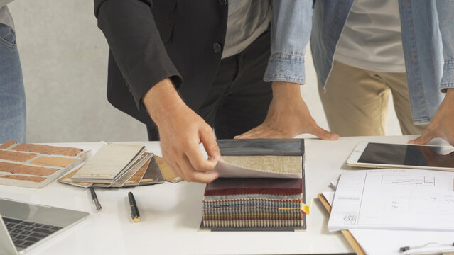 A group of multi ethnic business designer team talk, communicate, discuss, and work in meeting room on construction site, present ideas to colleagues. People lifestyle. Corporation