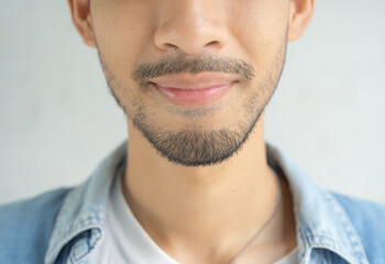 Obraz premium Close up of smiling middle east arab business man eyes and face with beard. Texture of the black eye is visible. Macro detail of iris.