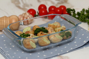 Stuffed snails with vegetables in a glass container
