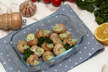 Stuffed snails with vegetables in a glass container