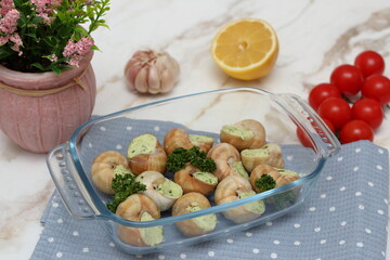 Stuffed snails with vegetables in a glass container
