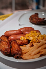 French fries, chicken and sausages, unhealthy fast food meal