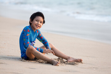 Kids play on tropical beach.  Children build sand castle. Child playing at sea on summer family vacation. Water fun, sun protection. Little boy at ocean shore. Travel with kids.
