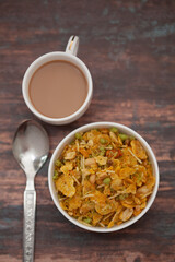 Close-Up of crunchy Indian mixture snacks with hot tea or Coffee time and handmade cookies (biscuits).