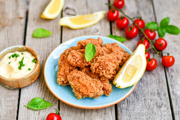 
 Crispy  deep Fried   Chicken strips and wedges potato. Breaded  with cornflakes chicken  Breast Fillets  with chilly peppers and fresh   basil on wooden rustic background