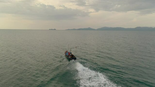 DRONE Film of small fishing boat of the coast at Koh Samui island in southern Thailand - drone fly by and partial circeling of the small vessel