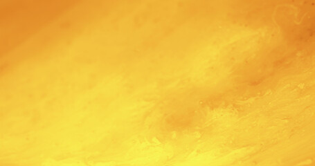 Yellow color texture. Paint splash. Watercolor blend. Defocused golden orange bright glow decorative abstract art copy space background.