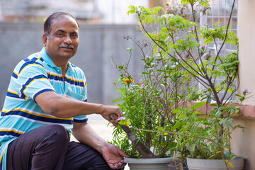 Portrait of active senior man gardening