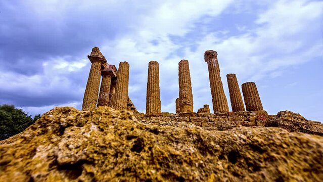 Time lapse shot of dark clouds flying over Valle Dei Templi with Ancient Columns And Pillars