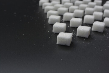 Sugar cubes pattern on shiny grey background. Abstract, minimal style.