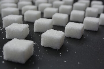 Sugar cubes pattern on shiny grey background. Abstract, minimal style.