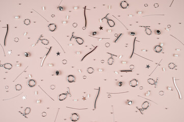 Jewelry making tools and accessories on pastel pink background. Accessories for making jewelry. Needlework.