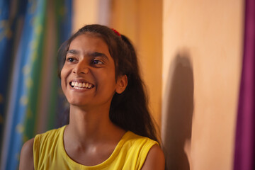 Portrait of a teenage girl looking elsewhere and smiling