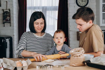 Mother's day happy mom with two sons in the kitchen