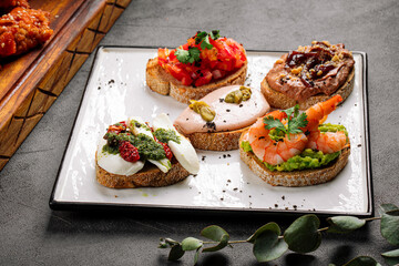 Assorted bruschetta toasts with different toppings