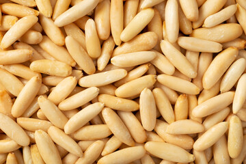 Food background of roasted European pine nuts, top view.