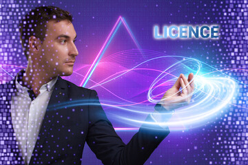 Business, Technology, Internet and network concept. Young businessman working on a virtual screen of the future and sees the inscription: Licence