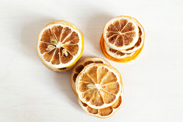 Three stacks of dried lemon slices on a white background