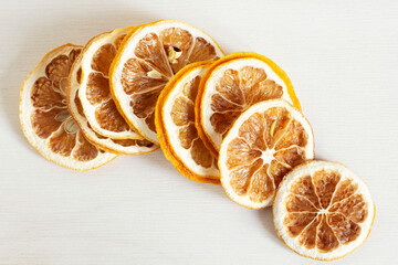 Dried slices of lemons on a gray background.