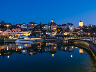 Murten, Switzerland - March 24.2022: Blue hour townscape of medieval Murten or Morat, a bilingual municipality in the lake district of the canton of Fribourg.