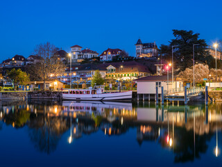 Fototapeta na wymiar Murten, Switzerland - March 24.2022: Blue hour townscape of medieval Murten or Morat, a bilingual municipality in the lake district of the canton of Fribourg.
