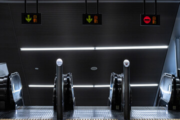 Abstract view of escalators in Metro station used to transport commuters during rush hour. The signs in Japanese says "Automatic"