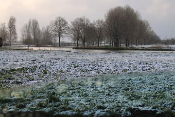 April snow on the 's-Gravenweg and its meadows in Nieuwerkerk