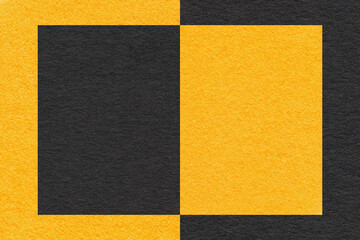 Texture of craft black and yellow paper background, half two colors, macro. Structure of golden craft cardboard.